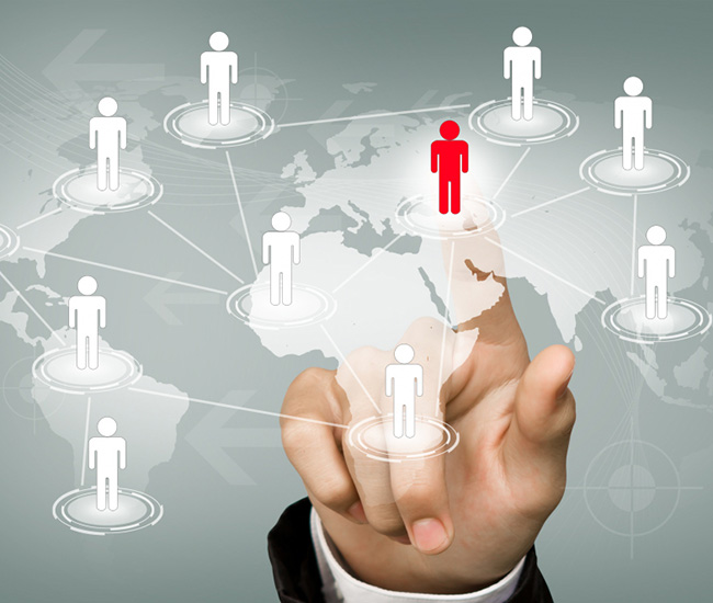 A person uses a laptop displaying a website builder interface, with a smartphone and tablet showing the same website design; green plants are visible at the top corners of the workspace. A person uses a laptop displaying a website builder interface, with a smartphone and tablet showing the same website design; green plants are visible at the top corners of the workspace.