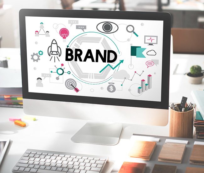 A person uses a laptop displaying a website builder interface, with a smartphone and tablet showing the same website design; green plants are visible at the top corners of the workspace. A person uses a laptop displaying a website builder interface, with a smartphone and tablet showing the same website design; green plants are visible at the top corners of the workspace.